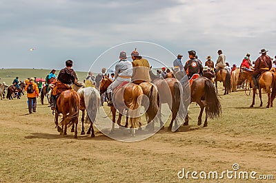 Horseback spectators on steppe, Nadaam horse race, Mongolia Editorial Stock Photo